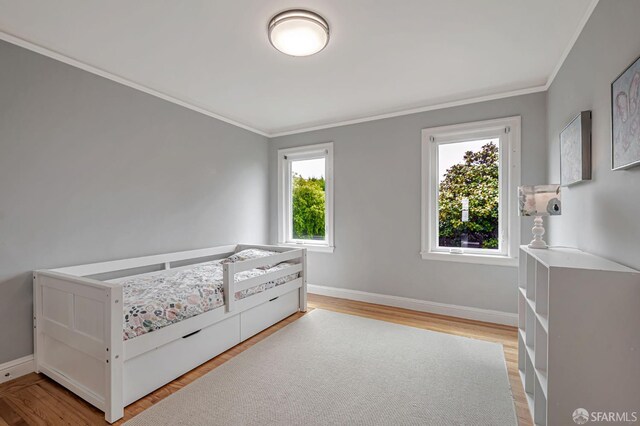 1655 24th Ave, San Francisco, CA 94122 - bedroom featuring crown molding, light wood-style flooring, and baseboards