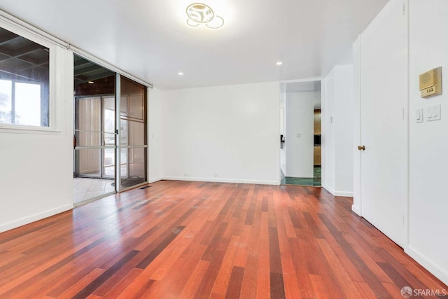 spare room with wood-type flooring