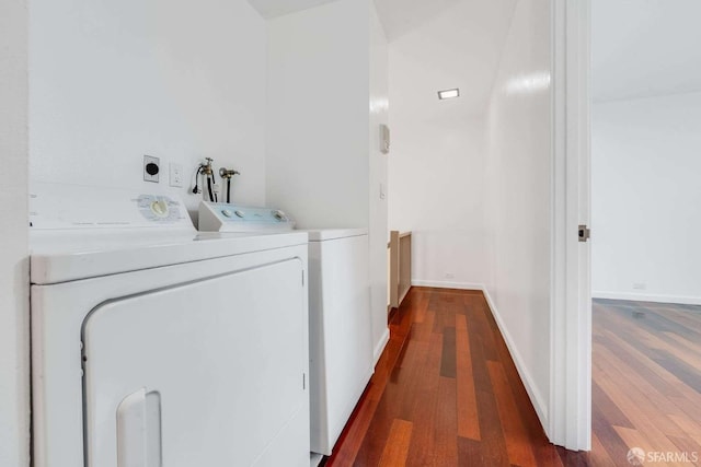 laundry area featuring washing machine and clothes dryer and dark hardwood / wood-style flooring