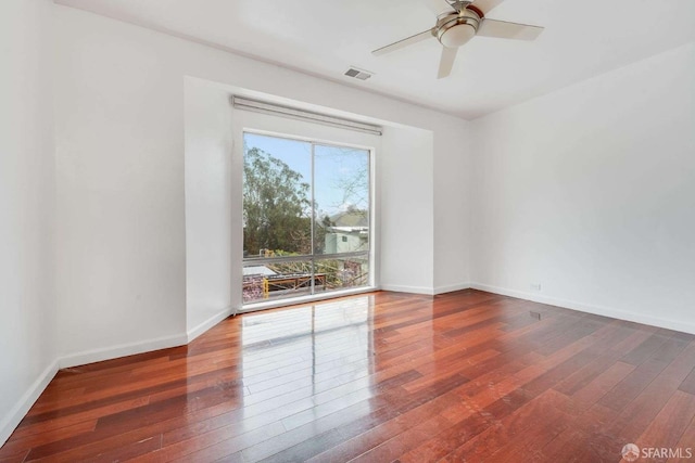 unfurnished room with dark hardwood / wood-style floors and ceiling fan