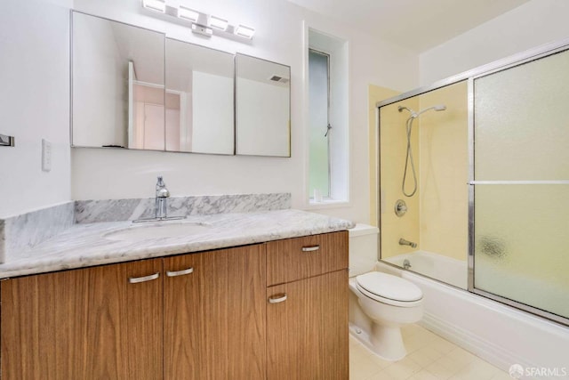 full bathroom with vanity, toilet, and combined bath / shower with glass door