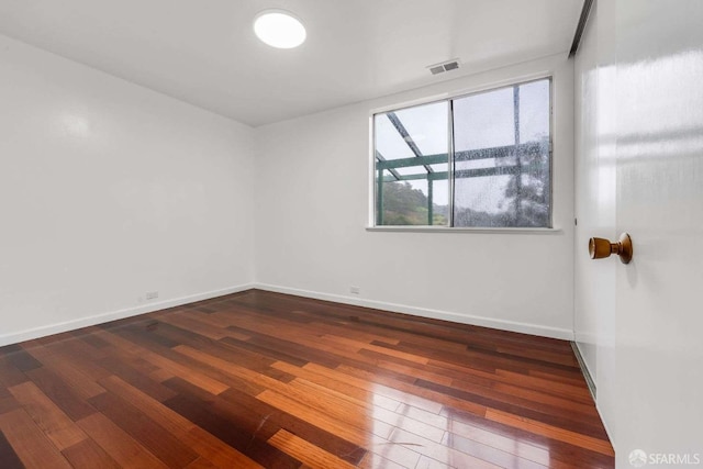 spare room with dark hardwood / wood-style floors