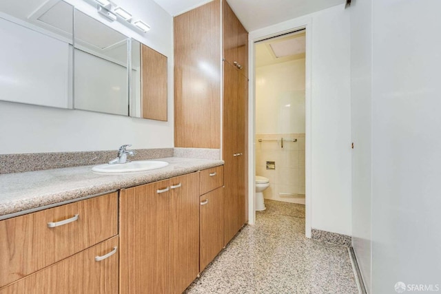 bathroom featuring vanity, tile walls, and toilet