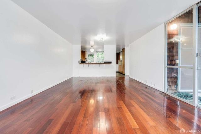 unfurnished living room featuring hardwood / wood-style floors