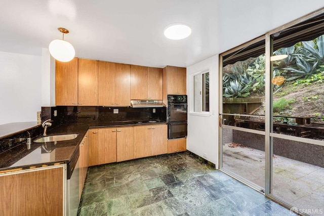 kitchen with hanging light fixtures, sink, decorative backsplash, and black appliances