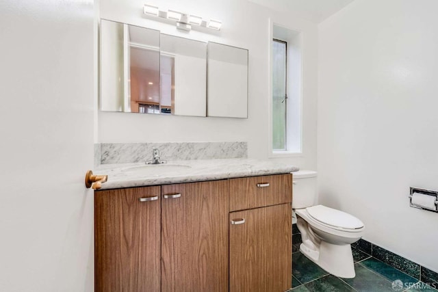 bathroom featuring vanity, tile patterned flooring, and toilet