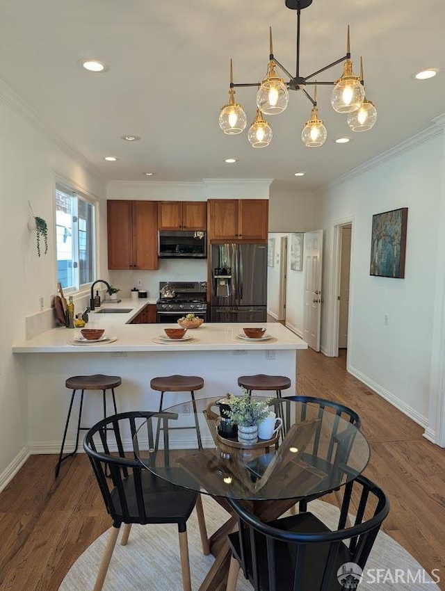 192 Ridgeway Ave, Oakland, CA 94611 - kitchen with gas range oven, stainless steel microwave, fridge with ice dispenser, brown cabinets, and crown molding