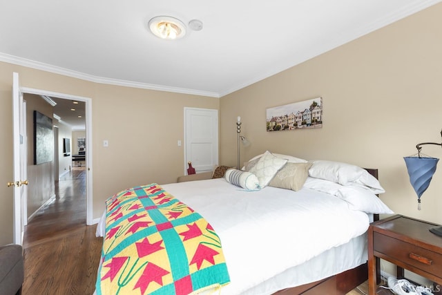 bedroom featuring baseboards, ornamental molding, and wood finished floors