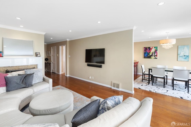 living area featuring recessed lighting, visible vents, and wood finished floors