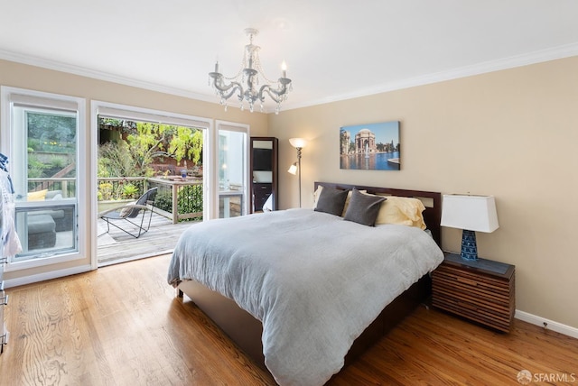 bedroom with access to outside, ornamental molding, wood finished floors, and a notable chandelier