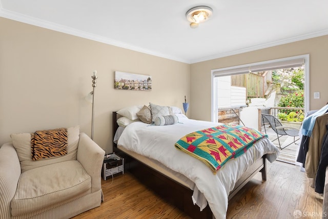 bedroom with access to outside, ornamental molding, and wood finished floors