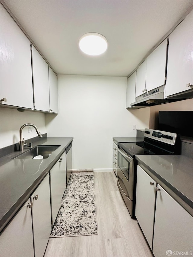 kitchen with white cabinetry, sink, light hardwood / wood-style flooring, and stainless steel appliances