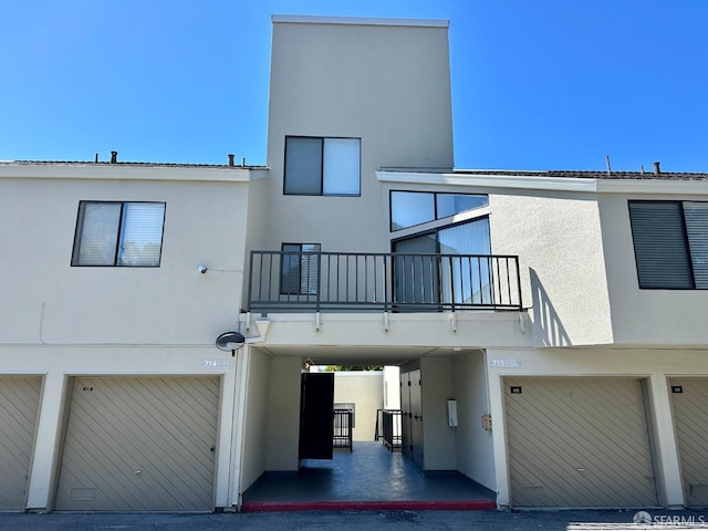 exterior space featuring a balcony and a garage