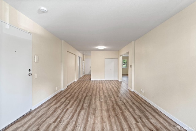 unfurnished room with light wood-type flooring