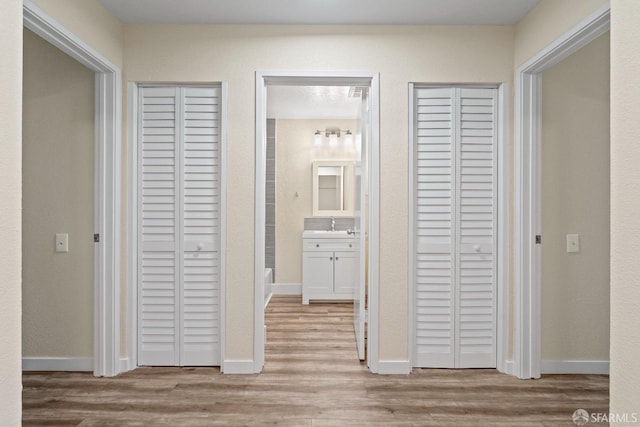 corridor with light wood-type flooring