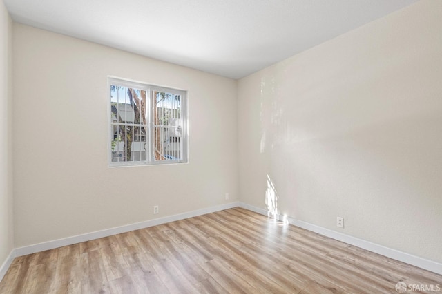 spare room with light hardwood / wood-style flooring