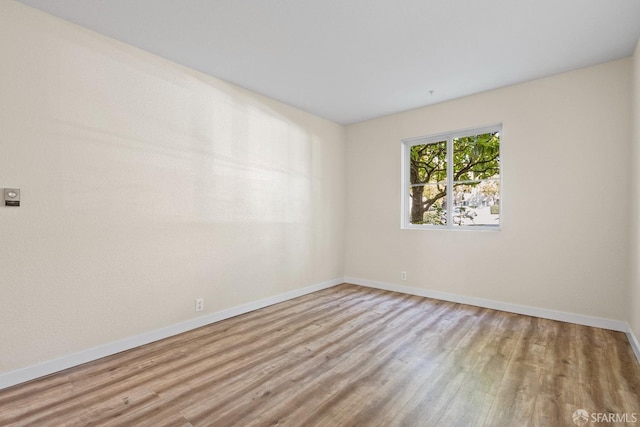 spare room featuring light wood-type flooring