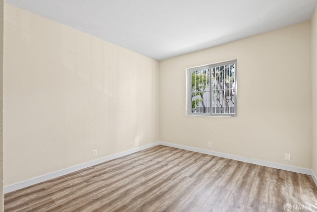 spare room featuring light hardwood / wood-style floors