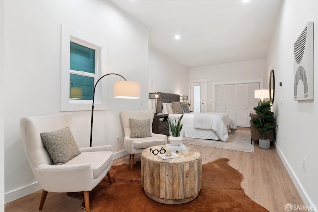 bedroom with wood finished floors, baseboards, a closet, and recessed lighting