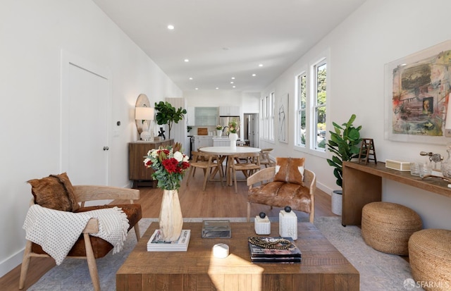 living room featuring light wood finished floors, baseboards, and recessed lighting