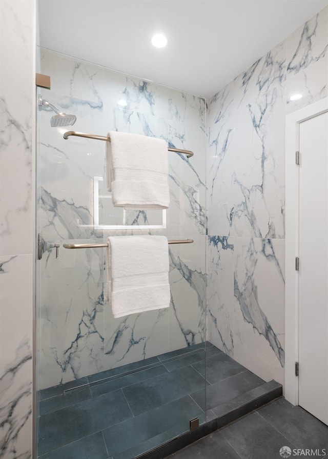 full bathroom with a marble finish shower