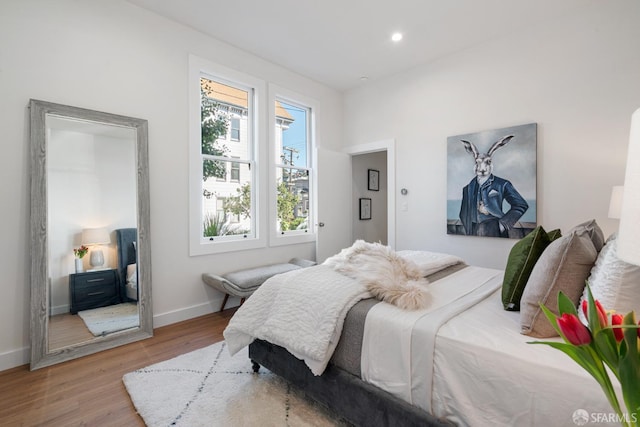 bedroom with baseboards, recessed lighting, and wood finished floors
