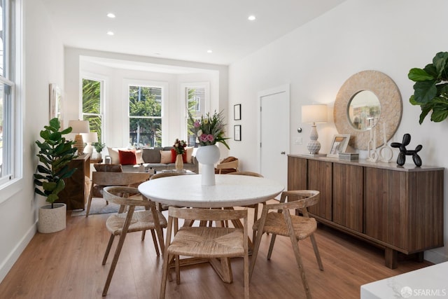 dining room with light wood-style flooring, baseboards, and recessed lighting