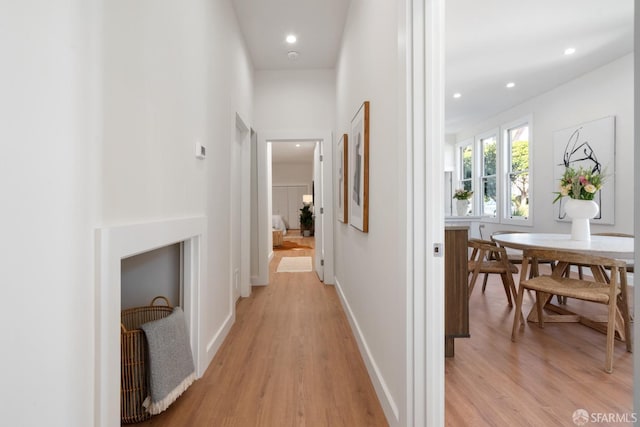 corridor with recessed lighting, light wood finished floors, and baseboards