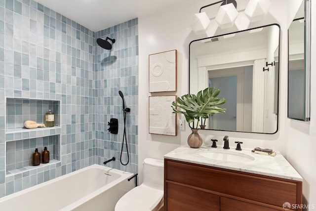 full bathroom with tiled shower / bath combo, vanity, and toilet