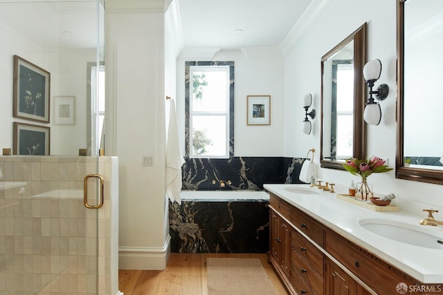 bathroom featuring vanity, crown molding, shower with separate bathtub, and hardwood / wood-style flooring