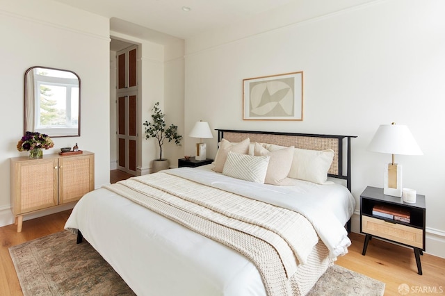 bedroom with hardwood / wood-style flooring