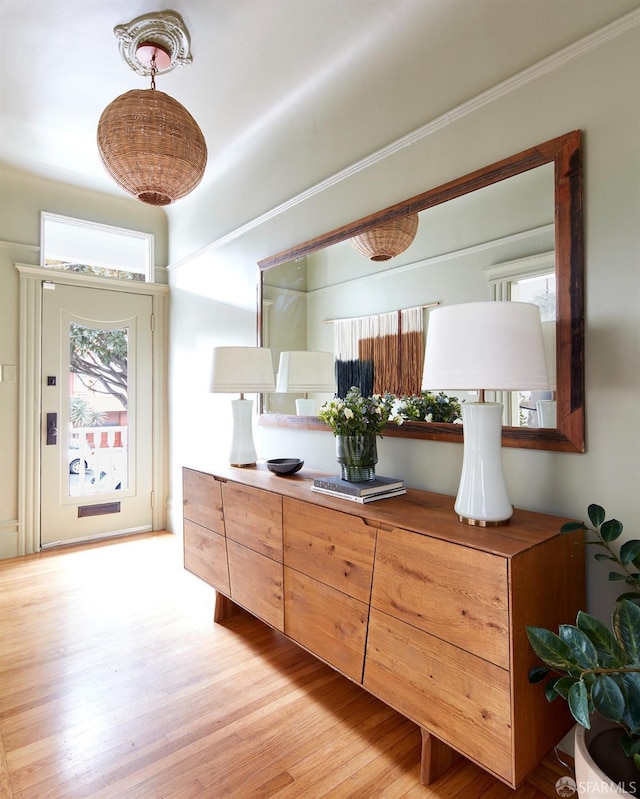 kitchen with decorative light fixtures and light hardwood / wood-style flooring