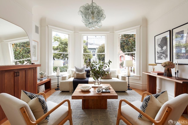 sunroom / solarium with a chandelier