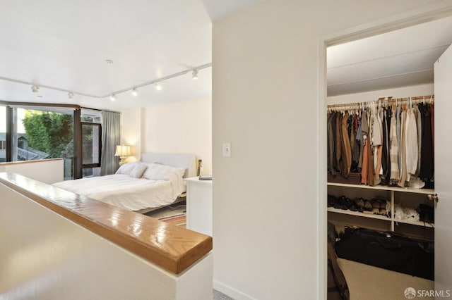 bedroom with a closet and track lighting