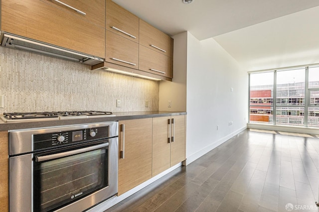 420 Mission Bay Blvd Unit 706, San Francisco, CA 94158 - kitchen featuring decorative backsplash, appliances with stainless steel finishes, modern cabinets, baseboards, and dark wood-type flooring