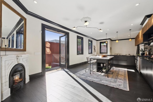 dining area with ornamental molding and dark hardwood / wood-style floors