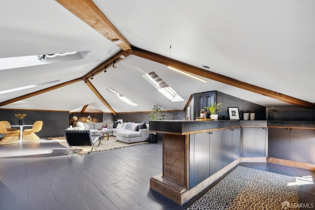 bonus room with dark wood-type flooring and vaulted ceiling with skylight