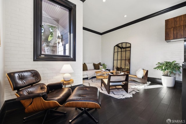 living room with wood-type flooring, brick wall, and crown molding