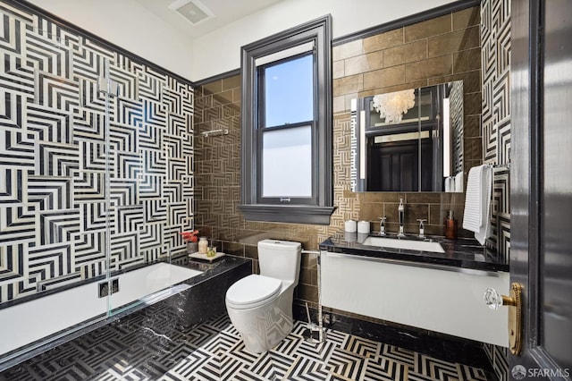 full bathroom with tile walls, tile patterned flooring, vanity, toilet, and bathing tub / shower combination