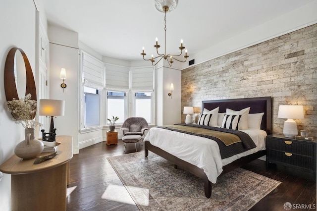 bedroom featuring dark wood-type flooring and a notable chandelier