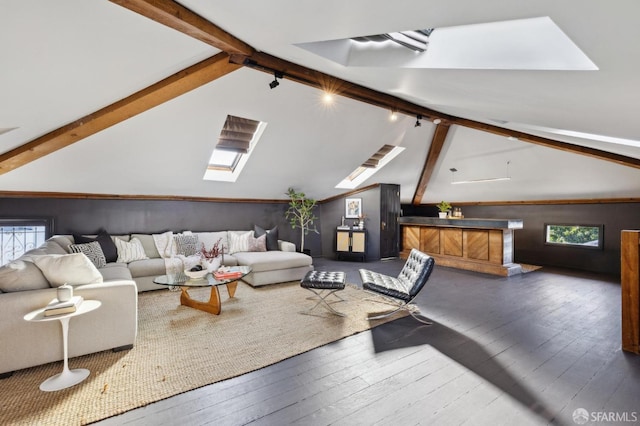 living room featuring hardwood / wood-style flooring, lofted ceiling with skylight, and rail lighting