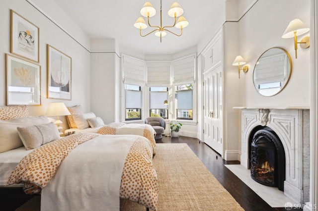 bedroom featuring dark hardwood / wood-style floors and a chandelier