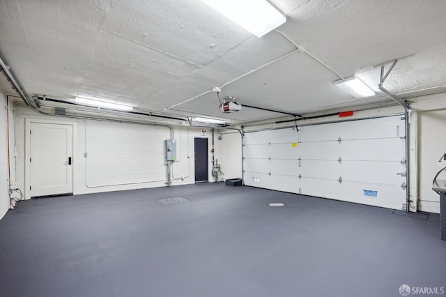 garage with a garage door opener and electric panel