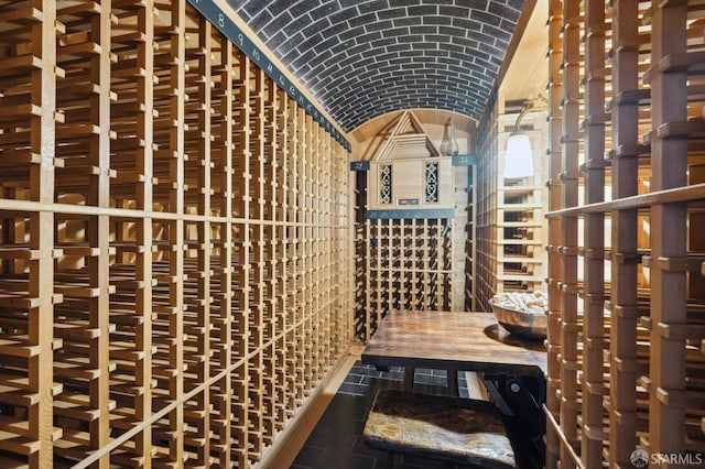 wine cellar featuring brick ceiling and lofted ceiling