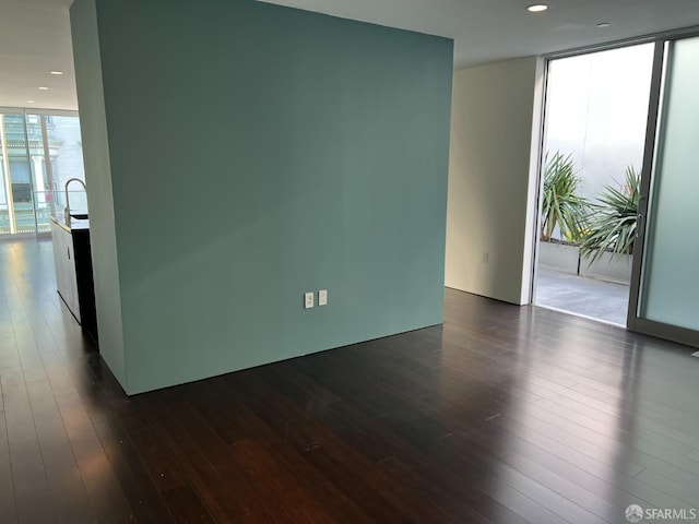 unfurnished room featuring dark hardwood / wood-style floors and floor to ceiling windows