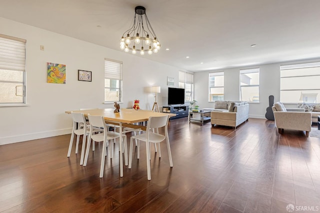 dining area featuring a chandelier, dark wood-style flooring, healthy amount of natural light, recessed lighting, and baseboards