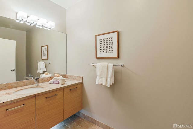 bathroom with tile patterned flooring, vanity, and baseboards