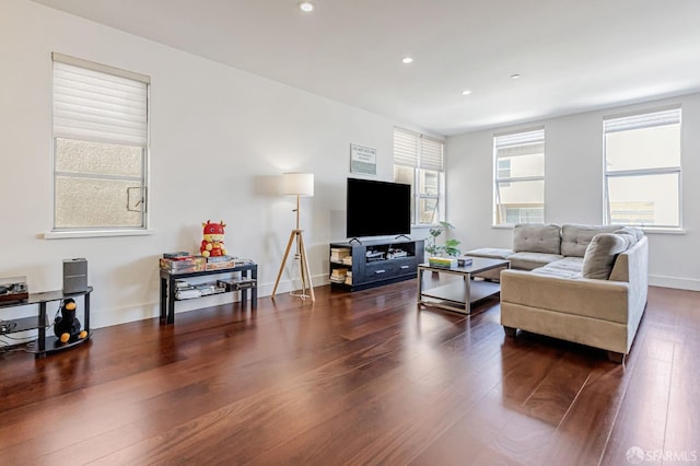 living room featuring recessed lighting, dark wood-style floors, and baseboards