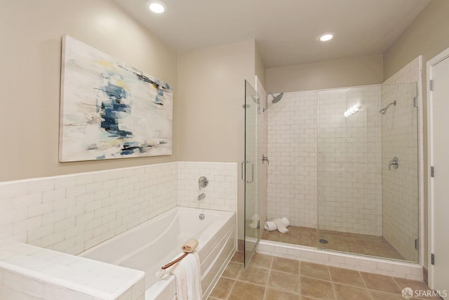 bathroom featuring a stall shower, a garden tub, recessed lighting, and tile patterned flooring