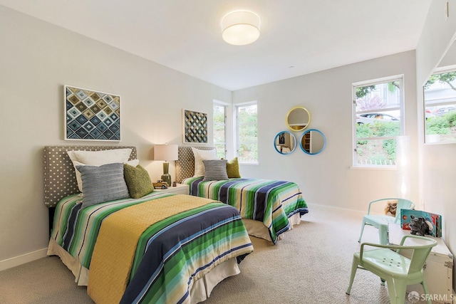 bedroom featuring carpet floors and baseboards